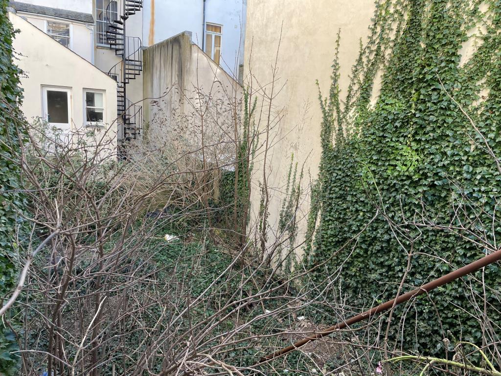 Lot: 73 - LAND WITH POTENTIAL CLOSE TO HOVE SEAFRONT - View of overgrown land